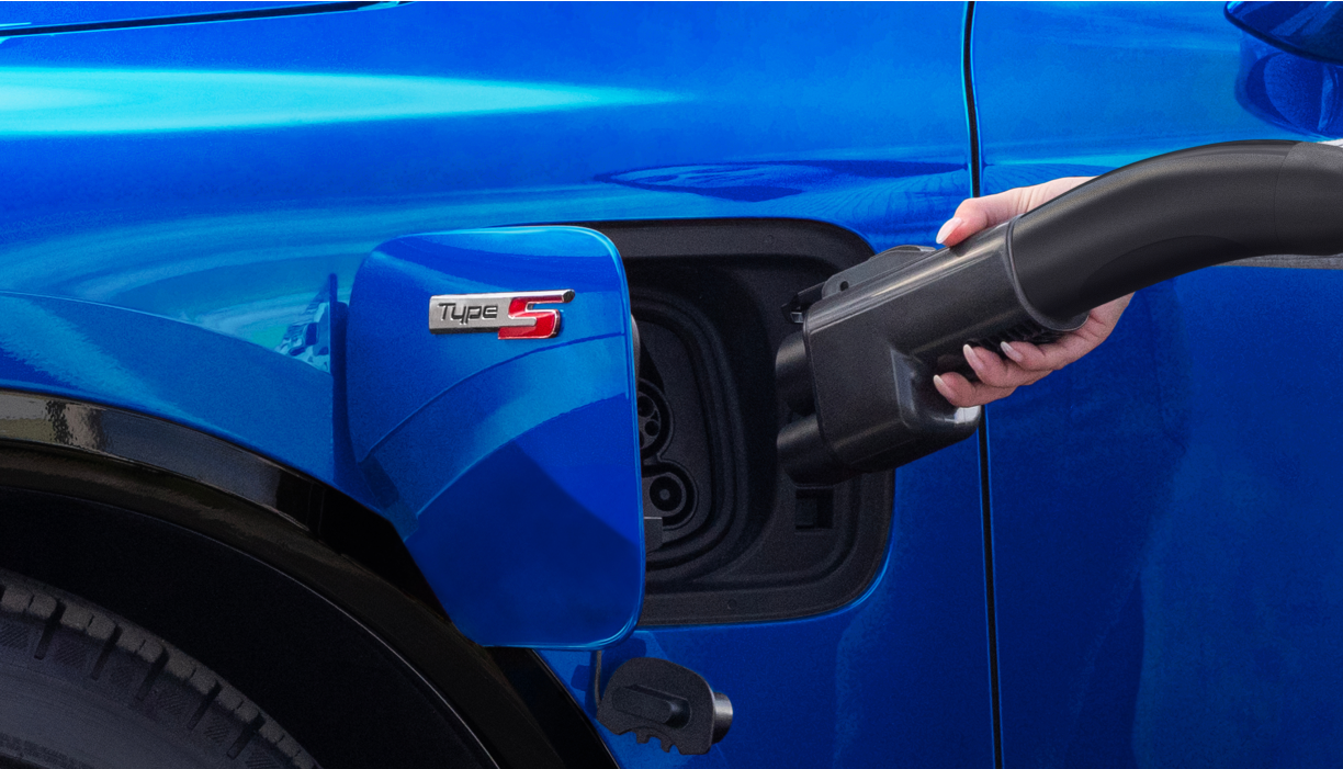 Side view of vehicle charging port, cable and adapter.