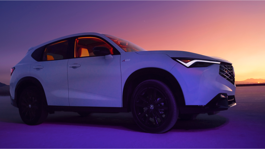 A stationary 2025 Acura ADX with purple and pink hues in the sky.