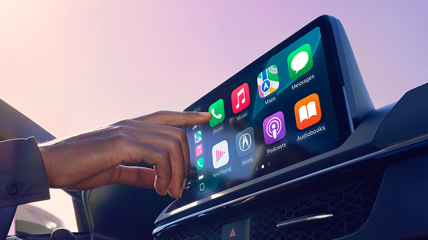 Cllose-up of driver using Google-built in on the dashboard display. 