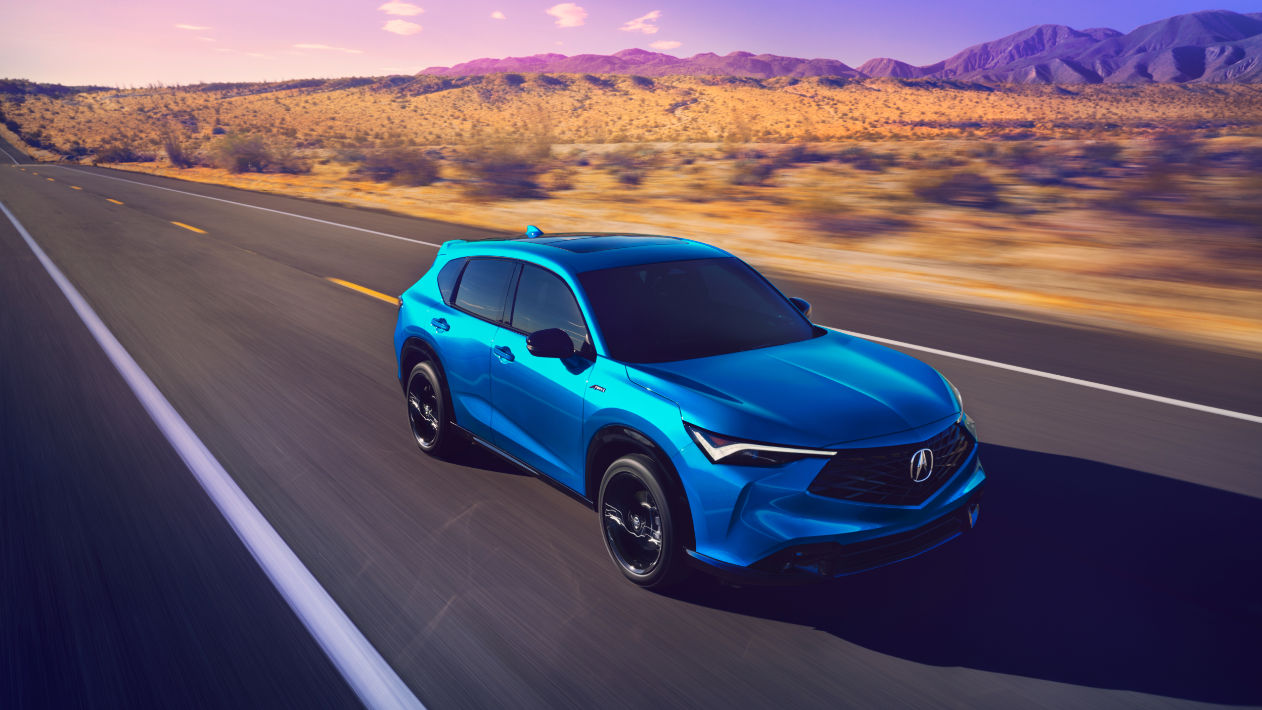 Medium shot of blue Acura ADX on a desert highyway. 