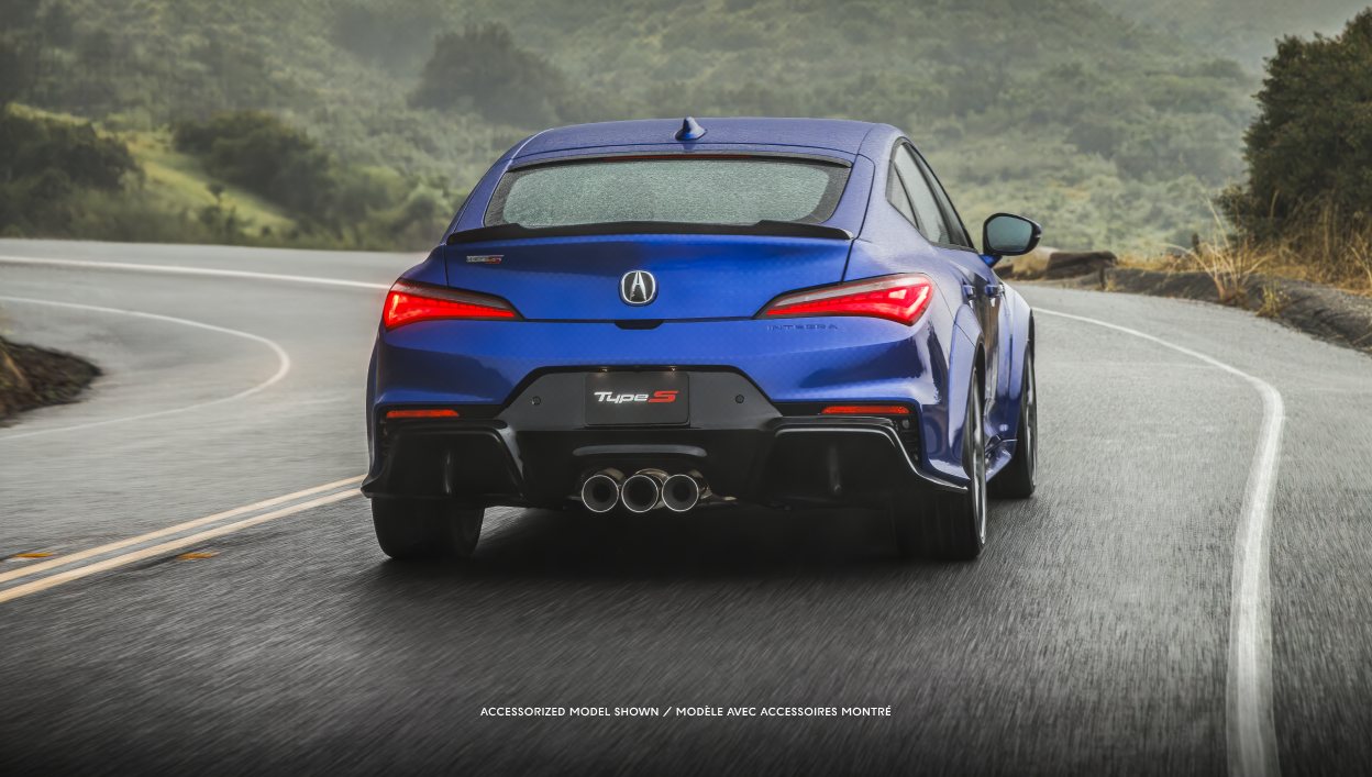 Rear-view of a blue Integra driving on the highway.