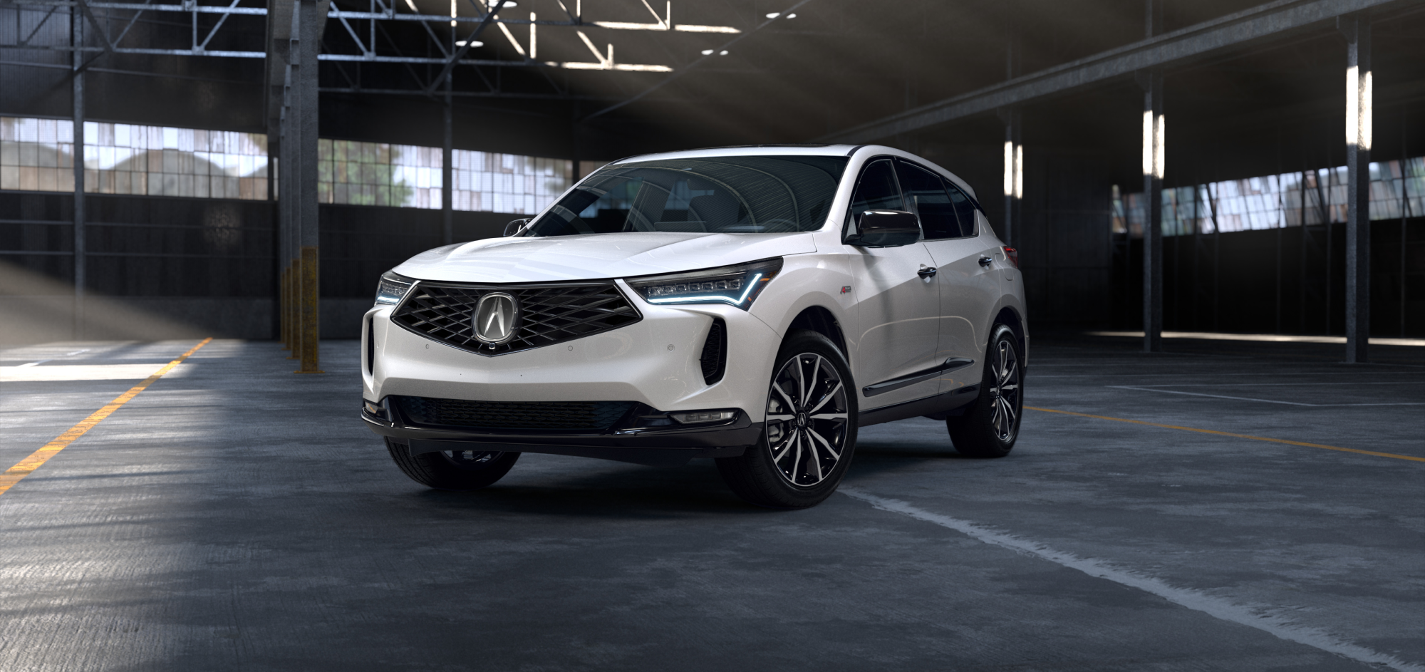 Side driver-side view of white 2025 RDX parked inside an empty warehouse.
