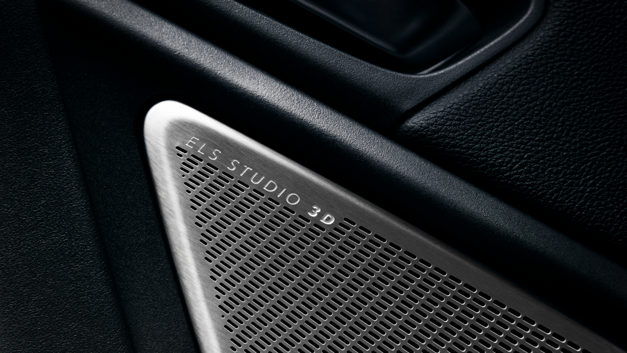 A hand pulls a paddle shifter behind the steering wheel.