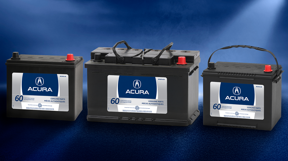 3 Acura batteries side-by-side against a hazy red background. 