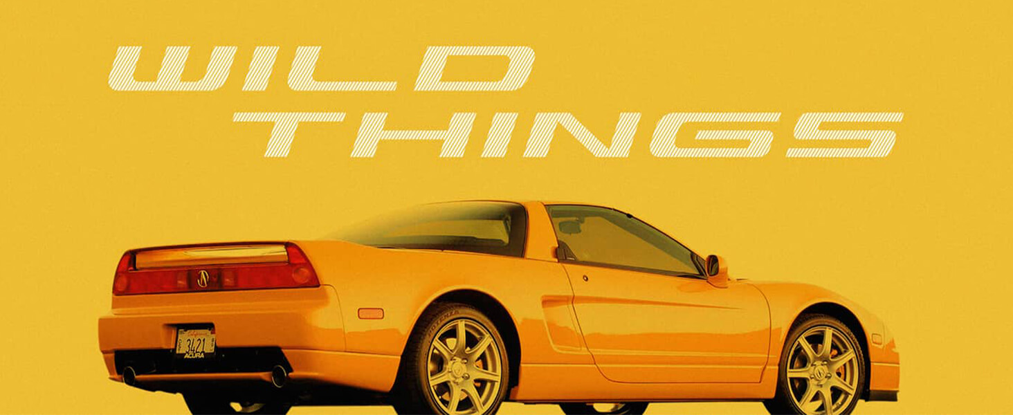 Side view of yellow 1989 Acura NSX. / Vue latérale de l’Acura NSX 1989 jaune.